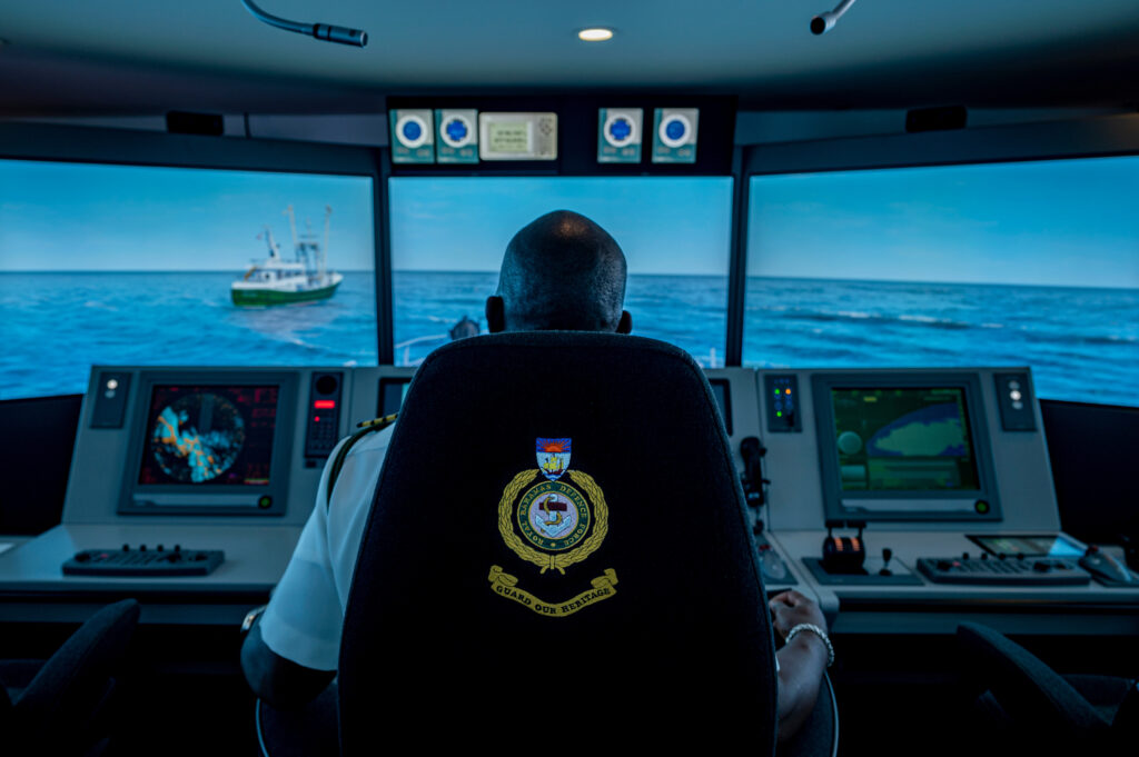 Royal Bahamas Defence Force (RBDF) Squadron Commanding Officer and Sea Training Officer William Sturrup inside a ship training simulator on the RBDF base in Nassau, Bahamas. The RBDF is on the front lines in the fight against illegal, unreported and unregulated (IUU) fishing in The Bahamas.